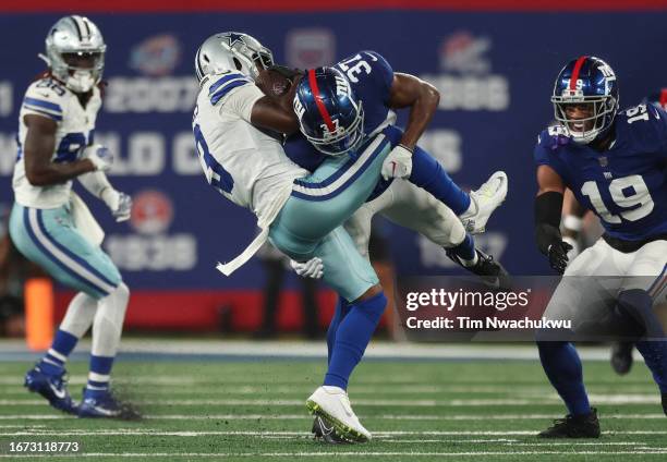 Tre Hawkins III of the New York Giants tackles Brandin Cooks of the Dallas Cowboys during the second quarter at MetLife Stadium on September 10, 2023...