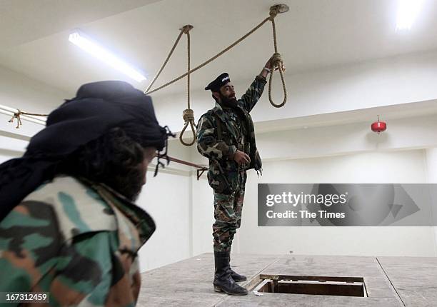 Free Syrian Army soldiers in a room where political prisoners were hanged by Al-Assad forces inside the central prison on April 23 in Darkoush,...