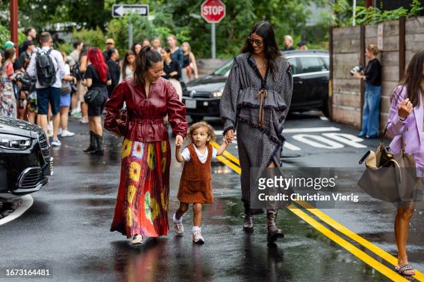 Babba Rivera with child wears grey coat outside Ulla Johnson on September 10, 2023 in New York City.