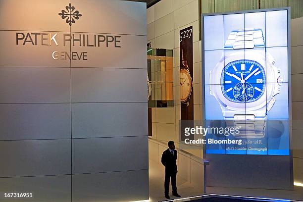 Security guard stands on duty at the Patek Philippe SA booth during the Baselworld watch fair in Basel, Switzerland, on Wednesday, April 24, 2013....