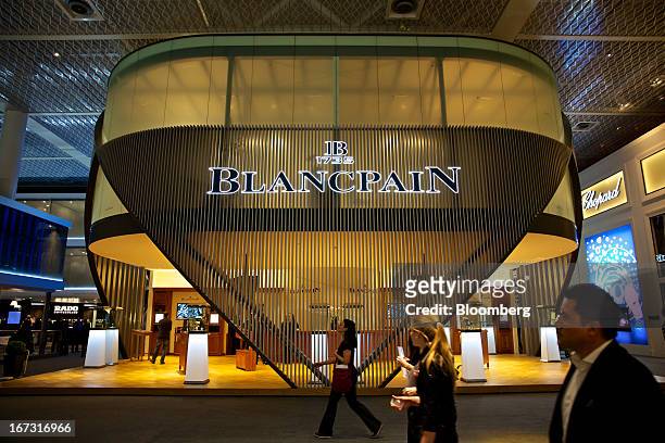 Visitors pass the Blancpain booth, a luxury unit of Swatch Group AG, during the Baselworld watch fair in Basel, Switzerland, on Wednesday, April 24,...