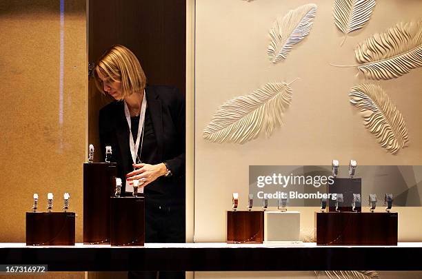 An employee works on a display of wristwatches at the Carl F. Bucherer booth during the Baselworld watch fair in Basel, Switzerland, on Wednesday,...