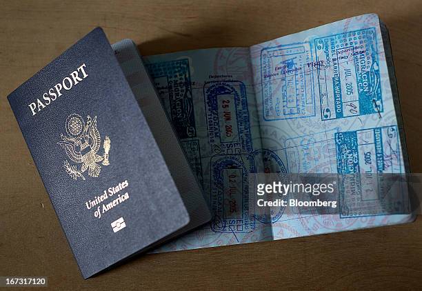 Passports are arranged for a photograph in New York, U.S., on Tuesday, April 23, 2013. A court challenge by federal immigration agents seeking to...