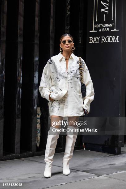 Rocky Barnes wears white button shirt, skirt, boots, black bag outside Jason Wu on September 10, 2023 in New York City.