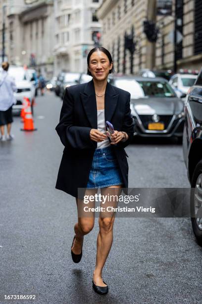 Eva Chen wears navy blazer, denim skirt outside Jason Wu on September 10, 2023 in New York City.