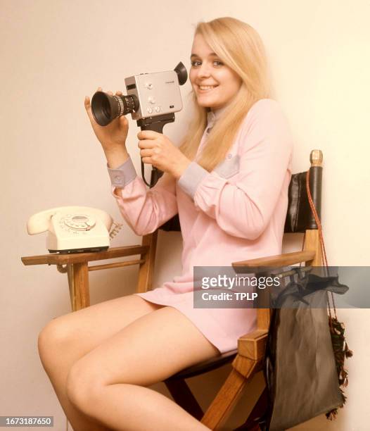 Irish actress Sinéad Cusack poses for a portrait with a telephone and movie camera in London, England, September 2, 1970.