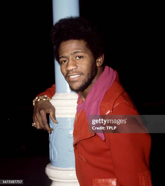 American singer Al Green poses for a portrait wearing red jacket while hugging a lamp post in London, England, December 10, 1971.