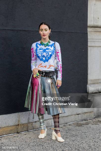 Guest wears pleated skirt with mixed colores outside 3.1 Phillip Lim on September 10, 2023 in New York City.