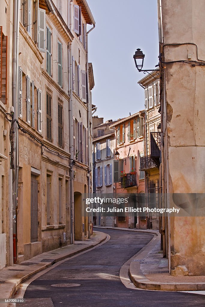 A narrow street with Provencal style facades.