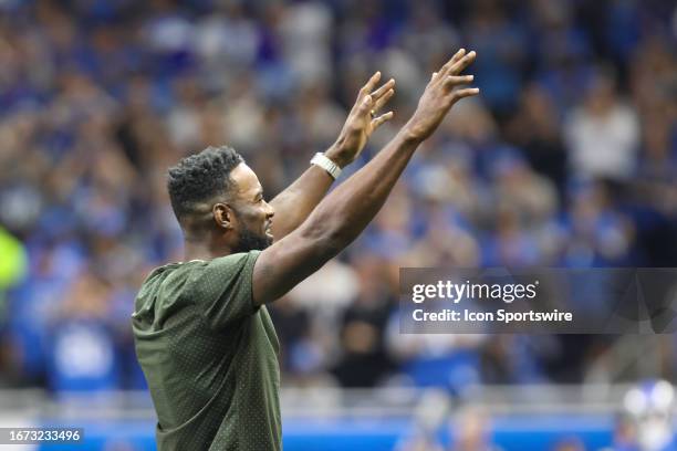 Hall of Fame Detroit Lions wide receiver Calvin Johnson waves to fans during a recognition ceremony during the first quarter of an NFL football game...