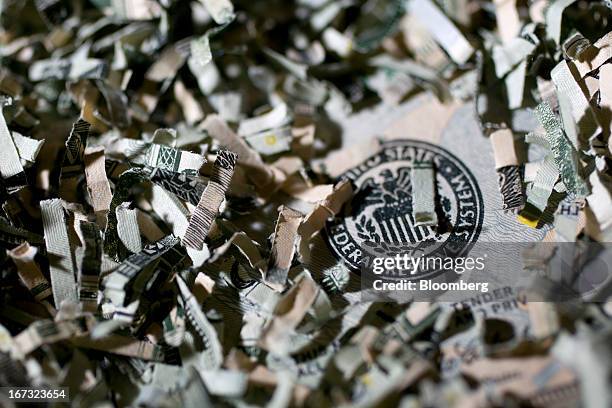 Shredded currency surrounds the seal of the U.S. Federal Reserve in Washington, D.C., U.S., on Wednesday, April 24, 2013. The S&P 500 has surged 134...