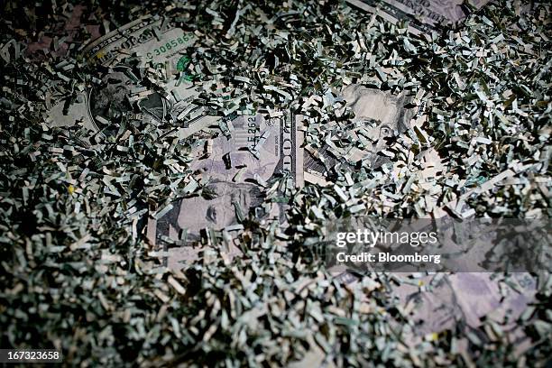 Shredded currency surrounds U.S. Dollar bills in Washington, D.C., U.S., on Wednesday, April 24, 2013. The S&P 500 has surged 134 percent from a...