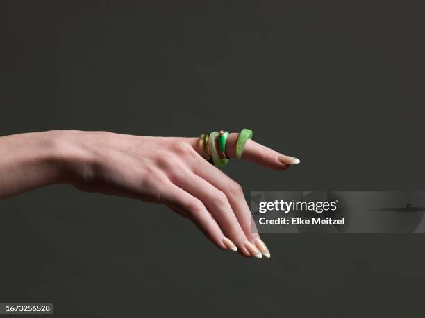 elegant female hand pointing - verde jade imagens e fotografias de stock