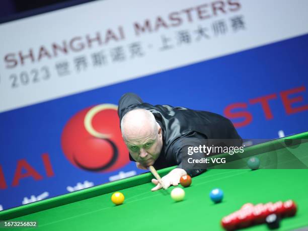 John Higgins of Scotland plays a shot in the first round match against Deng Haohui of China on day 1 of World Snooker Shanghai Masters 2023 at...