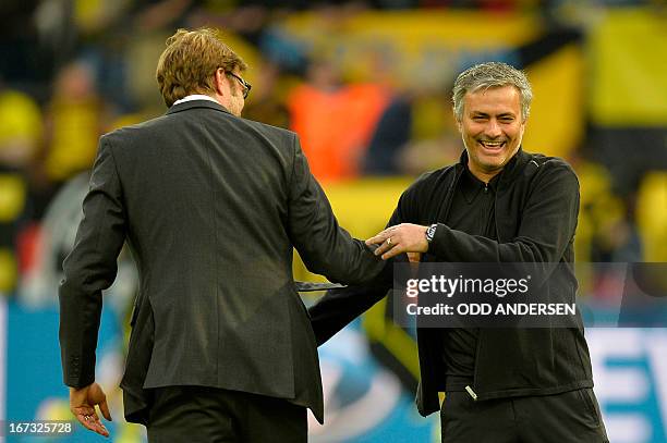 Dortmund's head coach Juergen Klopp shares a laugh with Real Madrid's Portuguese coach Jose Mourinho before the UEFA Champions League semi final...