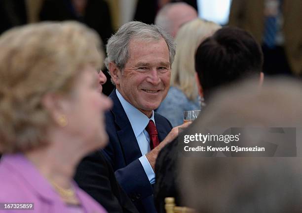 Former President George W. Bush attends a signing ceremony inside the Freedom Hall for the joint use agreement between the National Archive and the...