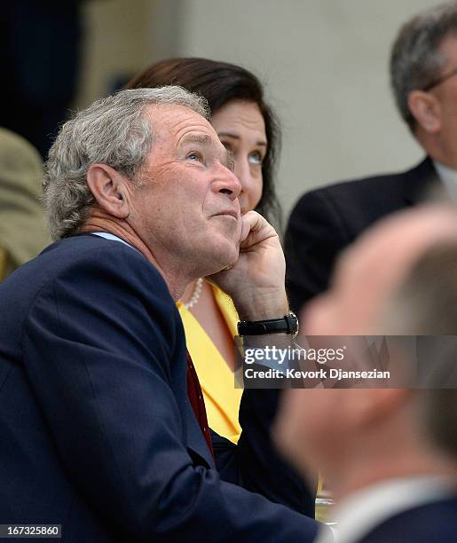 Former President George W. Bush looks at the 360-degree LED high definition video wall inside the Freedom Hall as he participates in a signing...