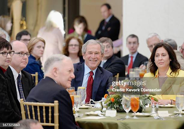 Former President George W. Bush attends a signing ceremony inside the Freedom Hall for the joint use agreement between the National Archive and the...