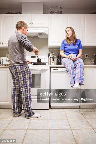 couple making breakfast. - leigh cook stock pictures, royalty-free photos & images