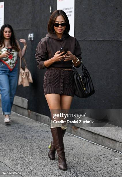 Aimee Song is seen wearing a brown Phillip Lim outfit, black bag and black sunglass with brown boots outside the 3.1 Phillip Lim show during NYFW S/S...