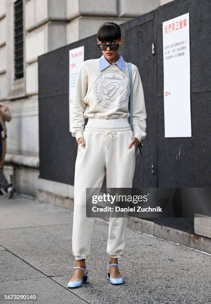 Katya Tolstova is seen wearing a white Phillip Lim sweatshirt and sweatpants with baby blue shoes outside the 3.1 Phillip Lim show during NYFW S/S...