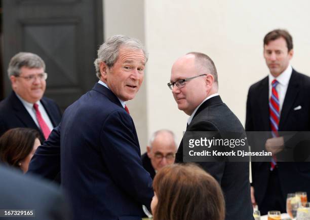 Former President George W. Bush and Alan Lowe, director of the George W. Bush Presidential Center arrive for a signing ceremony for the joint use...