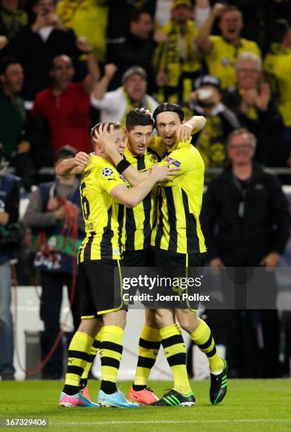 Robert Lewandowski of Borussia Dortmund celebrates scoring the opening goal with Sven Bender and Neven Subotic of Borussia Dortmund during the UEFA...