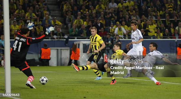 Robert Lewandowski of Borussia Dortmund scores the opening goal past goalkeeper Diego Lopez of Real Madrid during the UEFA Champions League Semi...