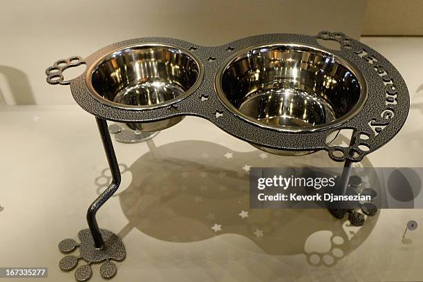 Steel dog bowls with paw shaped feet given as a gift to Presidents George W. Bush sit on display at the George W. Bush Presidential Center on the...