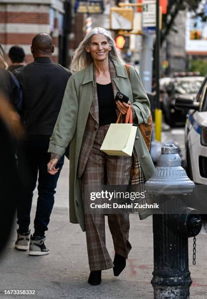 Model is seen wearing a green trench coat, plaid blazer and pants outside the 3.1 Phillip Lim show during NYFW S/S 2024 on September 10, 2023 in New...