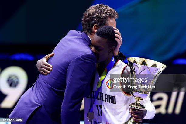 Dennis Schroder of Germany is congratulated by former Spanish player and FIBA Basketball World Cup 2023 global ambassador Pau Gasol after receiving...