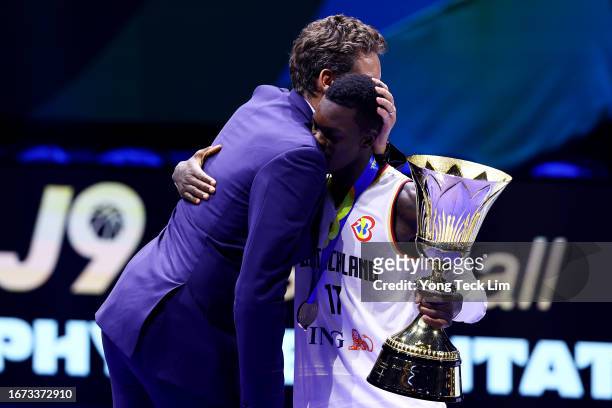 Dennis Schroder of Germany is congratulated by former Spanish player and FIBA Basketball World Cup 2023 global ambassador Pau Gasol after receiving...