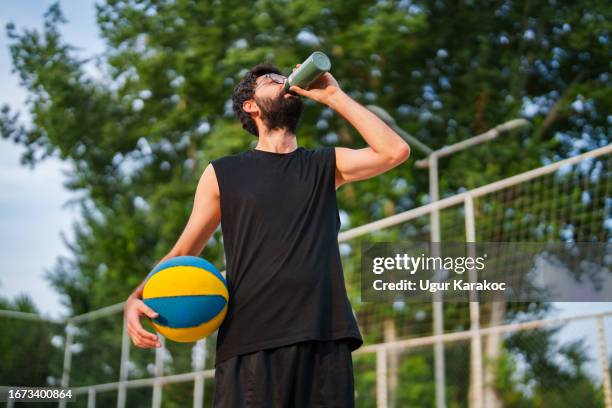 man drinking from a thermos on the basketball court - basketball player close up stock pictures, royalty-free photos & images