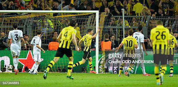 Dortmund's Polish striker Robert Lewandowski celebrates scoring 4:1 during the UEFA Champions League semi final first leg football match between...