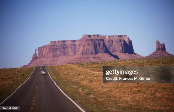 Car travels along road towards Monument Valley in Kayenta, Arizona, October 1990