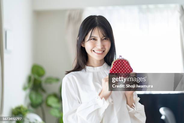 japanese woman with a wallet - frugality stock pictures, royalty-free photos & images