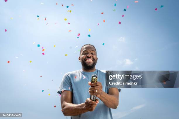 man exploding confetti - boom for real stock pictures, royalty-free photos & images