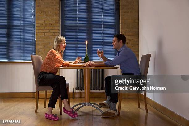 happy couple have dinner in apartment - norman window fotografías e imágenes de stock