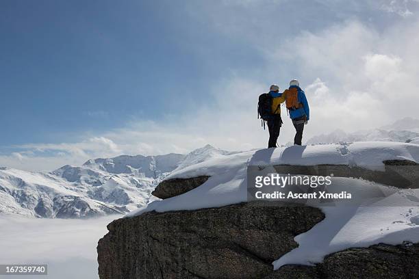 climbers stand on snowy mountain summit, look off - summit day 2 stock pictures, royalty-free photos & images