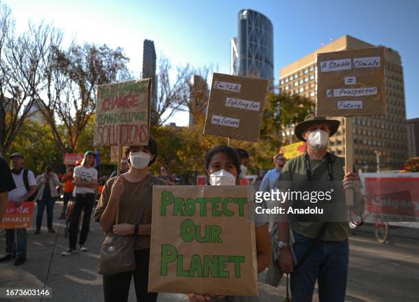 Activists hold a placard during the 'Rally for Climate Sanity' at the Calgary's Town Hall in opposition to the 24th World Petroleum Congress Opening...