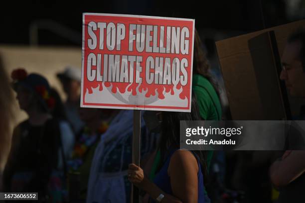 An activists holds a placard during the 'Rally for Climate Sanity' at the Calgary's Town Hall in opposition to the 24th World Petroleum Congress...