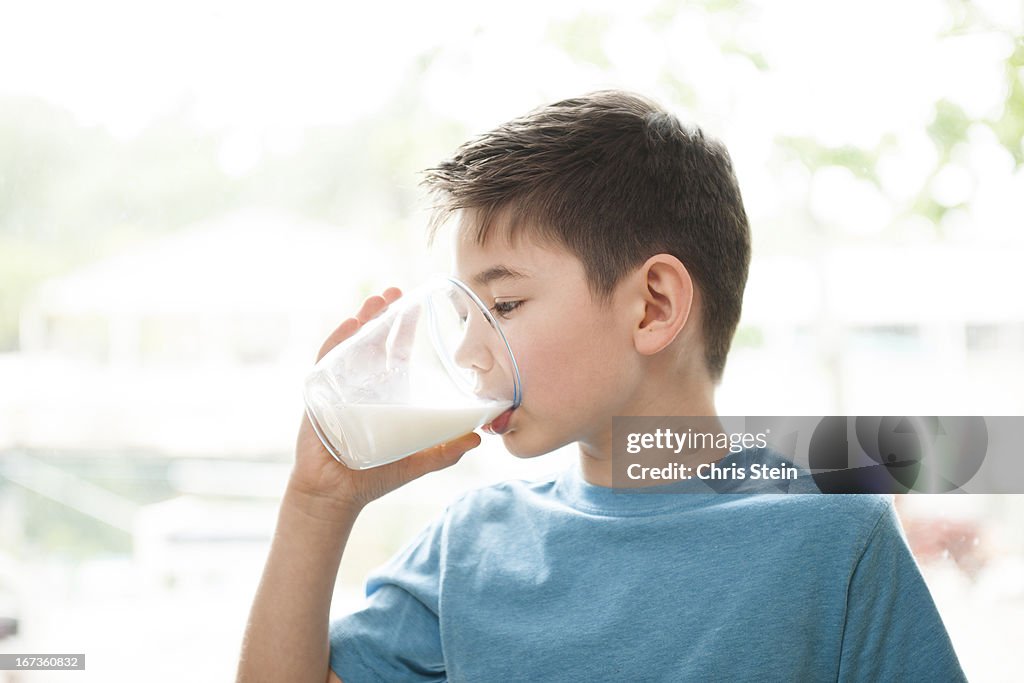 Young boy drinking milk