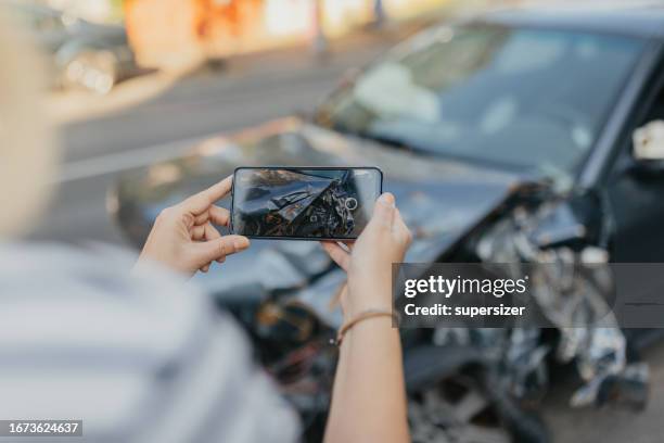 taking photo of wrecked car - verkeersongeluk stockfoto's en -beelden