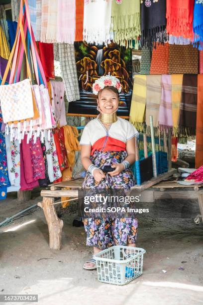 Padaung long-neck tribe woman is seen sitting at her booth at the Baan Tong Luang village in Mae Rim. The Padaung tribe is a subset of the Karenni,...