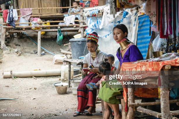 Padaung long-neck tribe women and their kids are seen inside the Baan Tong Luang village in Mae Rim. The Padaung tribe is a subset of the Karenni,...