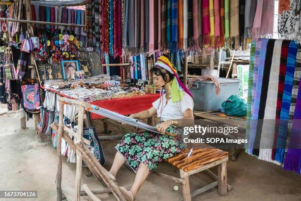 Padaung woman is seen weaving at the Baan Tong Luang village in Mae Rim. The Padaung tribe is a subset of the Karenni, which in turn is a subgroup of...