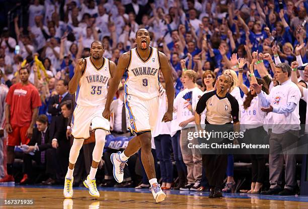 Serge Ibaka of the Oklahoma City Thunder celebrates ahead of Kevin Durant after Ibaka scored against the Houston Rockets during fourth quarter of...