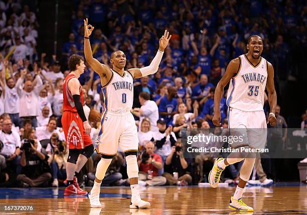 Russell Westbrook and Kevin Durant of the Oklahoma City Thunder celebrate after scoring against the Houston Rockets during the fourth quarter of Game...