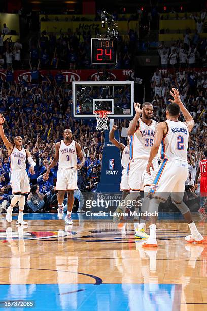 Thabo Sefolosha of the Oklahoma City Thunder celebrates with teammate Kevin Durant after making a three-pointer late in the fourth quarter against...