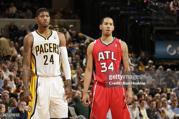 Paul George of the Indiana Pacers and Devin Harris of the Atlanta Hawks look on during the Game Two of the Eastern Conference Quarterfinals between...